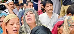  ?? PTI ?? Relatives and family members of veteran journalist Shujaat Bukhari, wail during his funeral procession, at Kreeri in Baramulla district of North Kashmir, on Friday. —