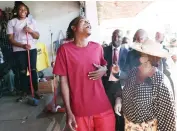  ?? ?? First Lady Dr Auxillia Mnangagwa shares a lighter moment with a young man she saw drinking alcohol during a clean-up campaign in Harare’s Central Business District yesterday