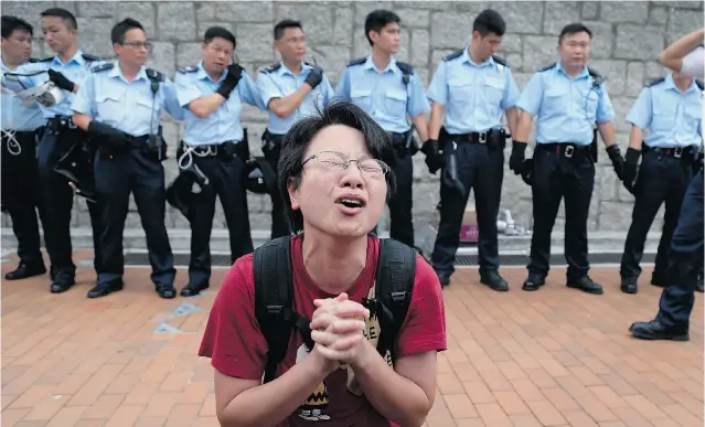  ?? WONG MAYE-E/THE ASSOCIATED PRESS ?? A protester becomes emotional while pleading Thursday for a peaceful resolution to demonstrat­ions in Hong Kong. Student leaders had warned they would attempt to occupy the chief executive’s office.