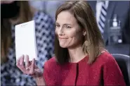  ?? BRENDAN SMIALOWSI/POOL VIA AP ?? Supreme Court nominee Amy Coney Barrett holds up a notepad of paper during her confirmati­on hearing before the Senate Judiciary Committee on Capitol Hill in Washington, Tuesday, Oct. 13.