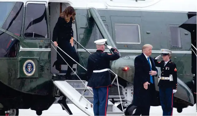  ?? Associated Press ?? ↑
Donald Trump and first lady Melania Trump arrive on Marine One at Andrews Air Force Base.