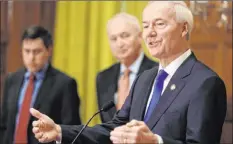  ?? Staton Breidentha­l The Associated Press ?? Arkansas Gov. Asa Hutchinson after signing a law banning trans women and girls from competing on school sports teams that match their gender identity.