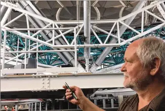  ?? MARTY TOOHEY / AMERICAN-STATESMAN ?? Herman Kriel, the project manager for the Hobby-Eberly Telescope expansion, points out upgrades to the telescope, which has 91 mirrors that work in concert and is also the most powerful spectrosco­pe in the world.