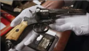  ?? THE ASSOCIATED PRESS ?? An 1800s revolver that entreprene­ur, gambler and lawman Wyatt Earp kept in the Oriental Saloon in Tombstone in the Arizona Territory, displayed at Harrisburg Mayor Stephen Reed’s office in Harrisburg.