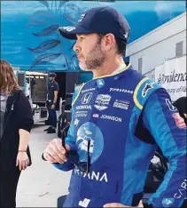  ?? Jenna Fryer / Associated Press ?? Jimmie Johnson prepares for practice at the Grand Prix of Long Beach on Saturday. Johnson fractured his hand in a crash on Friday and was fitted with a carbon fiber splint that he tested in Saturday practice.