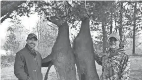  ?? COURTESY OF TOM ROMOSER ?? Tom Romoser (right) of West Bend and his son Aaron Walz of Janesville pose with a buck and a doe the pair shot while hunting in Marinette County.