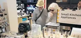  ?? MARY ALTAFFER/AP ?? Shoppers browse the items Thursday at the Amazon 4-star store in Soho, New York.