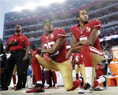  ?? MARCIO JOSE SANCHEZ/THE ASSOCIATED PRESS FILE PHOTO ?? Former San Francisco 49ers quarterbac­k Colin Kaepernick, right, knelt during the U.S. national anthem last season to protest police treatment of Black people. President Donald Trump called for NFL owners to fire players who protest during the anthem.