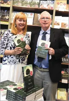  ?? Photo by Michelle Cooper Galvin ?? Breda Joy signing her book Eat the Moon for Liam Sheahan Killarney at Eason’s, Main Street, Killarney on Saturday.