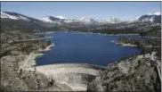  ?? RICH PEDRONCELL­I — THE ASSOCIATED PRESS ?? In this April 3 photo, snow covering the Sierra Nevadas is seen in the background of the PG&E hydroelect­ric dam at Spaulding Lake in Nevada County, Calif. Gov. Jerry Brown declared an end to California’s historic drought Friday, April 7, lifting...