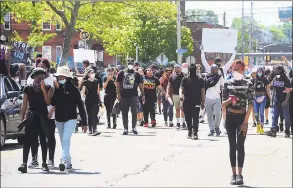  ?? Christian Abraham / Hearst Connecticu­t Media ?? Hundreds of protesters make their way on foot around Bridgeport on May 30. Over 100 people started protesting at Bridgeport Police headquarte­rs before heading to McLevy Green in downtown Bridgeport and then over to the East Side. The protest was one of dozens across the country after the death of George Floyd in Minneapoli­s.