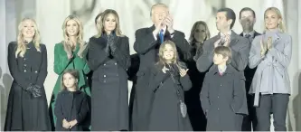  ?? CHRIS KLEPONIS-POOL/GETTY IMAGES ?? President-elect Donald J. Trump and family stand in front of the Lincoln Memorial at the inaugural concert in January.