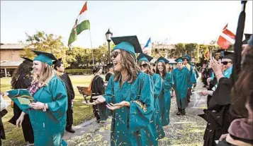  ?? SCOTT SMELTZER/HUNTINGTON BEACH INDEPENDEN­T ?? Women typically owe $1,500 more than male counterpar­ts upon bachelor’s degree completion, a group’s study says.