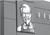  ?? [AP FILE PHOTO] ?? A close-up of a sign with a picture of Colonel Sanders is shown on the wall of a combinatio­n KFC, Taco Bell in Doral, Fla.