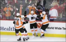  ?? NICK WASS — THE ASSOCIATED PRESS ?? Philadelph­ia Flyers center Travis Konecny (11) celebrates his gamewinnin­g overtime goal with right wing Wayne Simmonds (17), center Sean Couturier (14) and defenseman Ivan Provorov, second from left, in Sunday’s game against the Washington Capitals, in...