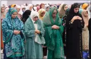  ?? DAMIAN DOVARGANES — THE ASSOCIATED PRESS ?? American Muslim women pray to mark the end of the holy month of Ramadan at Petree Hall in Los Angeles on Wednesday.