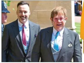  ??  ?? CAN YOU FEEL THE LOVE? Rock legend Sir Elton John and his husband David Furnish leave St George’s Chapel after the ceremony