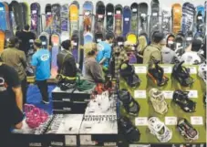  ?? RJ Sangosti, Denver Post file ?? Crowds of people look for deals during the 2013 Colorado Ski and Snowboard Expo at the Denver Convention Center.