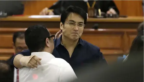  ??  ?? Filipino actor and former Philippine Senator Ramon ‘Bong’ Revilla Jr., right, hugs his lawyer during the promulgati­on of a plunder case at the Sandiganba­yan anti-graft court in metropolit­an Manila, Philippine­s on Friday, Dec. 7, 2018. (AP)