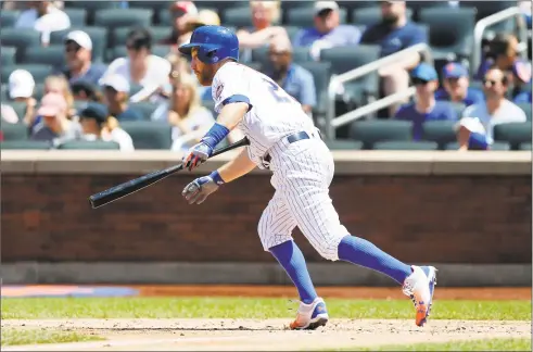  ?? Jim McIsaac / Getty Images ?? Todd Frazier of the New York Mets follows through on a fourth inning run-scoring single against the Detroit Tigers at Citi Field on Sunday in New York. The Mets won 4-3.