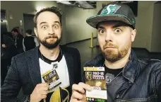  ??  ?? Greg Moore, left, and Justin Reves show off their press passes prior to seeing the Golden Knights play during a recent trip to Las Vegas.