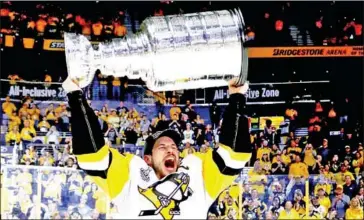  ?? AFP ?? Sidney Crosby of the Pittsburgh Penguins celebrates with the Stanley Cup on June 11, 2017, after his team beat the Nashville Predators.