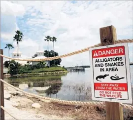  ?? Spencer Platt Getty Images ?? AFTER an alligator killed 2-year-old Lane Graves at a Disney World resort last month, company officials roped off the waterfront and posted warning signs.