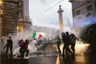  ?? Mauro Scrobogna / LaPresse ?? Demonstrat­ors and police clash Saturday during a protest in Rome over COVID-19 health passes that Italian workers must have to access their workplaces starting this Friday.