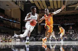  ?? JOE ROBBINS / GETTY IMAGES ?? Tennessee’s Jordan Bone (right) defends against Vanderbilt’s Aaron Nesmith last month. Bone is a three-year starter who leads the SEC in assists (6.6).