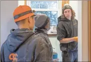  ?? Ellen M. Banner/The Seattle Times/TNS ?? Journeyman plumber Will Lane (r) talks about their upcoming job with apprentice­s Ricky Bui (l) and Tonya Miller. Apprentice­ship programs in the trades are facing a shortage of people. Tonya Miller used to be a nurse, then a teacher. Now she’s an apprentice with Harts Services, residentia­l plumbers.