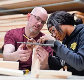  ?? ALLAN JUNG/TELEGRAM & GAZETTE ?? Freshman Denazha Buchanan of Worcester is taught to make a joint box by carpentry teacher Mike Cormier at Worcester Technical High School.