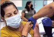  ?? Irfan Khan Los Angeles Times ?? A WOMAN gets a vaccine shot in L.A. in May. About 57% of California­ns have received at least one dose.