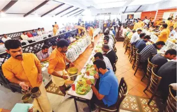  ?? Ahmed Ramzan/Gulf News ?? People enjoy Onasadhya, the traditiona­l Onam feast, at Salkara Restaurant in Dubai yesterday. Hundreds of thousands of residents sat down to enjoy a vegetarian feast across the UAE.