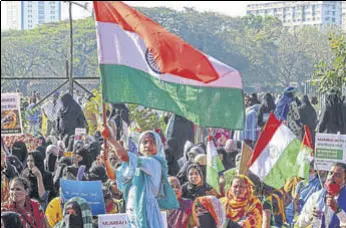  ?? PTI ?? A girl waves the Tricolor during a protest in Mumbai on Saturday to support the farmers’ ongoing agitation against the new farm laws in Delhi.
