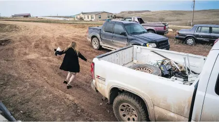  ?? PHOTOS: JABIN BOTSFORD/ THE WASHINGTON POST ?? Moriah Engdahl heads to her sister’s truck for the trip into town to speak against giving teachers in her Wyoming high school guns.