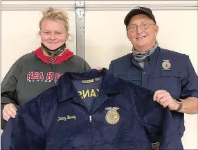  ??  ?? PRHS student Delaney Busby received her FFA jacket from teacher Perry Mason.