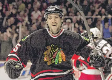  ?? | AP ?? Former Blackhawks right winger Eric Daze celebrates a goal against the rival RedWings in January 2003 at the United Center.