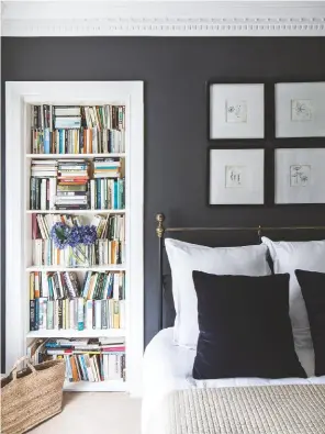  ??  ?? BEDROOM ‘I love the contrast and drama of the colours,’ says Amanda.
For a similar wall colour, try Railings estate emulsion, £47.95 for 2.5ltr, Farrow & Ball. Black metal bed frame, £650, Feather & Black. Velvet cushions, £15 each, H&M Home