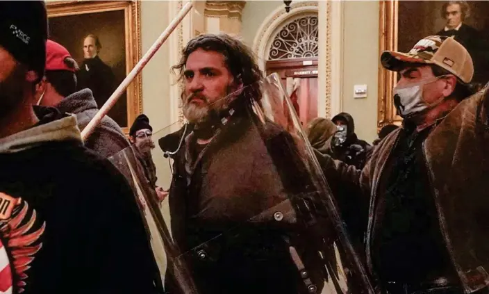  ?? ?? Dominic Pezzola outside the Senate chamber of the Capitol. Pezzola, a former member of the far-right Proud Boys, was sentenced to 10 years in prison. Photograph: Manuel Balce Ceneta/AP