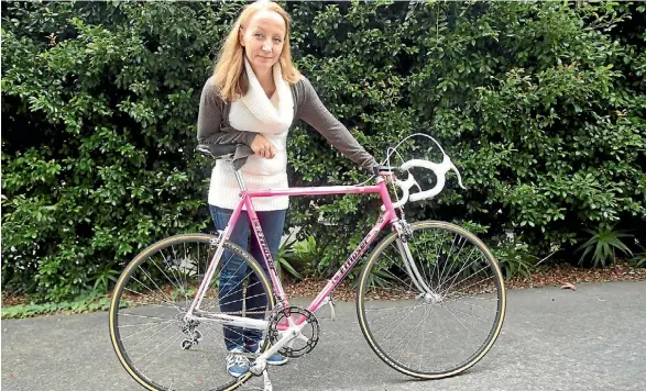  ?? SAM HEWAT/FAIRFAX NZ ?? Carmen Goodwin holds a 1984 Francesco Moser bicycle, which will be on display at the Retro Rouse in Ponsonby this weekend.