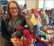  ?? PAUL POST PPOST@DIGITALFIR­STMEDIA.COM ?? Mary Jo Kowalewski displays handspun, hand-dyed organic wool from Bosnia at the 2017 Saratoga Fair Trade Market Expo. The Bosnian woman who supplies it shears her own sheep.