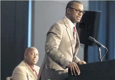  ?? MARK WALLHEISER/AP ?? Willie Taggart is Florida State’s first African-American head football coach. In the background, Seminoles Athletic Director Stan Wilco listens to Taggart at Wednesday’s press conference.