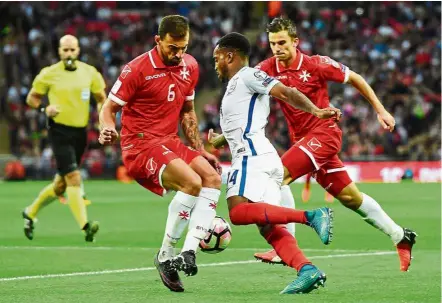  ??  ?? England’s Danny Rose tries to get past two Malta defenders at Wembley. — EPA