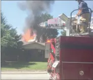  ?? Graham Thomas/Herald-Leader ?? Siloam Springs firefighte­rs battle a house fire Sunday morning at 2302 Mt. Olive St. It took nearly an hour to get the fire under control and the house was a total loss, according to SSFD officials.