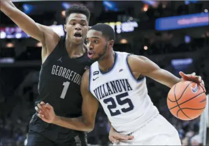  ?? CHRIS SZAGOLA — THE ASSOCIATED PRESS ?? Villanova’s Mikal Bridges, right, drives to the basket against Georgetown’s Jamorko Pickett during a game last season. Bridges, a graduate of Great Valley High School, worked out with the Philadelph­ia 76ers on Tuesday.