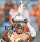  ?? REINHOLD MATAY/USA TODAY SPORTS ?? Tennessee running back Eric Gray holds up the MVP Trophy after defeating Indiana in the Gator Bowl on Jan. 2.