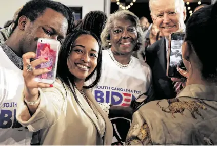  ?? Travis Dove / New York Times ?? Supporters take selfies with Democratic presidenti­al candidate former Vice President Joe Biden at a campaign event Tuesday in Columbia, S.C. Mobilizing black support in South Carolina has long been the foundation of Biden’s candidacy.