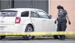  ?? PHOTOS BY JOE CAVARETTA/STAFF PHOTOGRAPH­ER ?? The stretch of West Sunrise Boulevard where Mobley was shot remained closed into Thursday morning as the police investigat­ion continued. At least seven vehicles were towed from the scene, including a white Dodge Magnum and a station wagon.