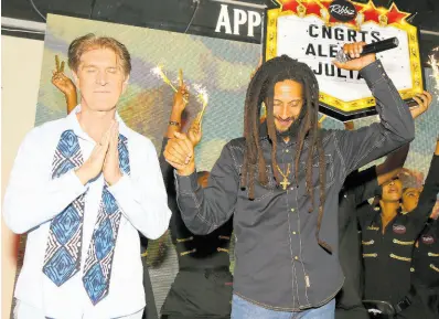  ?? ?? Alex Antaeus (left) and Julian Marley are congratula­ted as they appear on stage at Ribbiz.