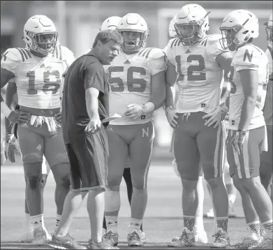  ??  ?? Simpson living his dream: In this photo, Nebraska walk-on, linebacker Brad Simpson (56) stands between Tre Bryant (18) and Luke Gifford (12) as they listen to special teams coach Bruce Read, during an NCAA college football practice in Lincoln, Neb....